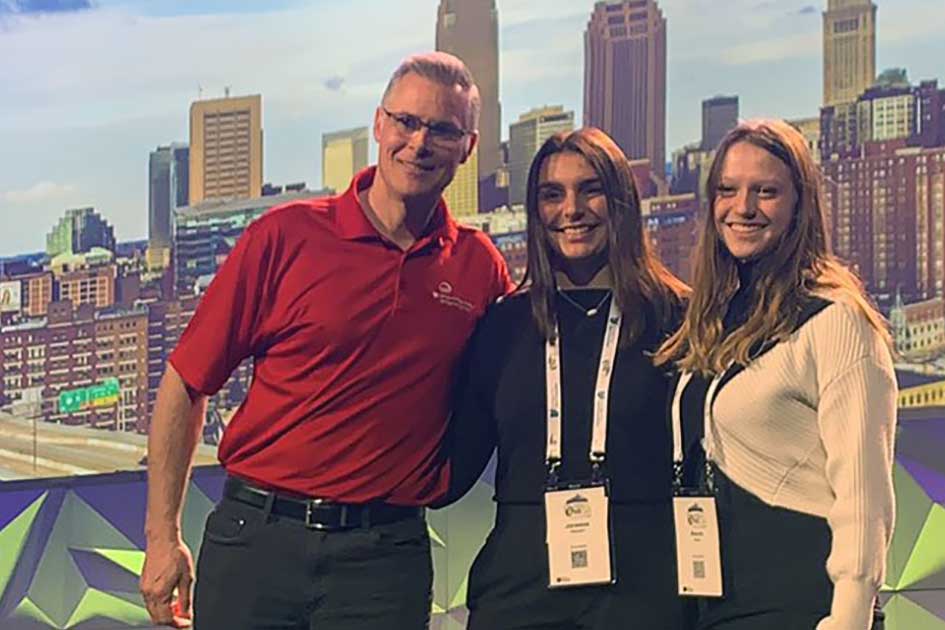Alexis Kulm (right) and Janessa Palmieri took second in a CTF competition at the spring WiCyS Conference. Congratulating the team is the organizer of the Carnegie Mellon CTF (left).
