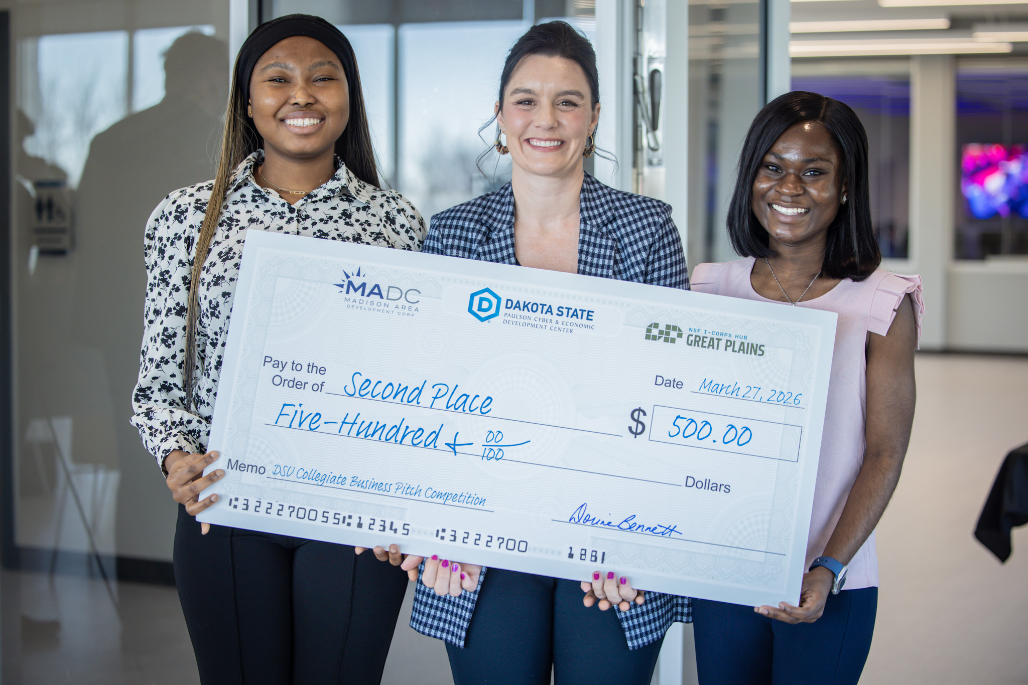 Tracey Kwareng, Brooke Rollag, and Jessica Senyah holding check