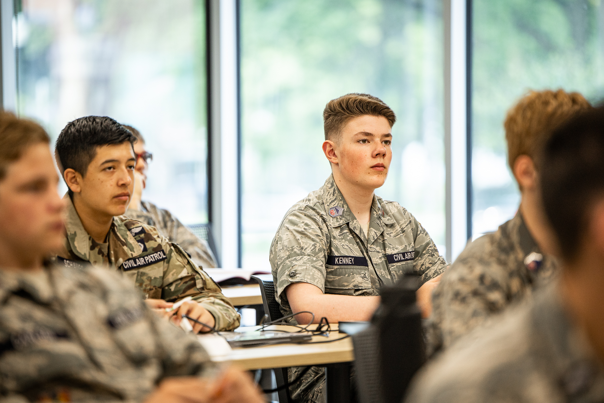 Cadets in fatigues listen to speakers