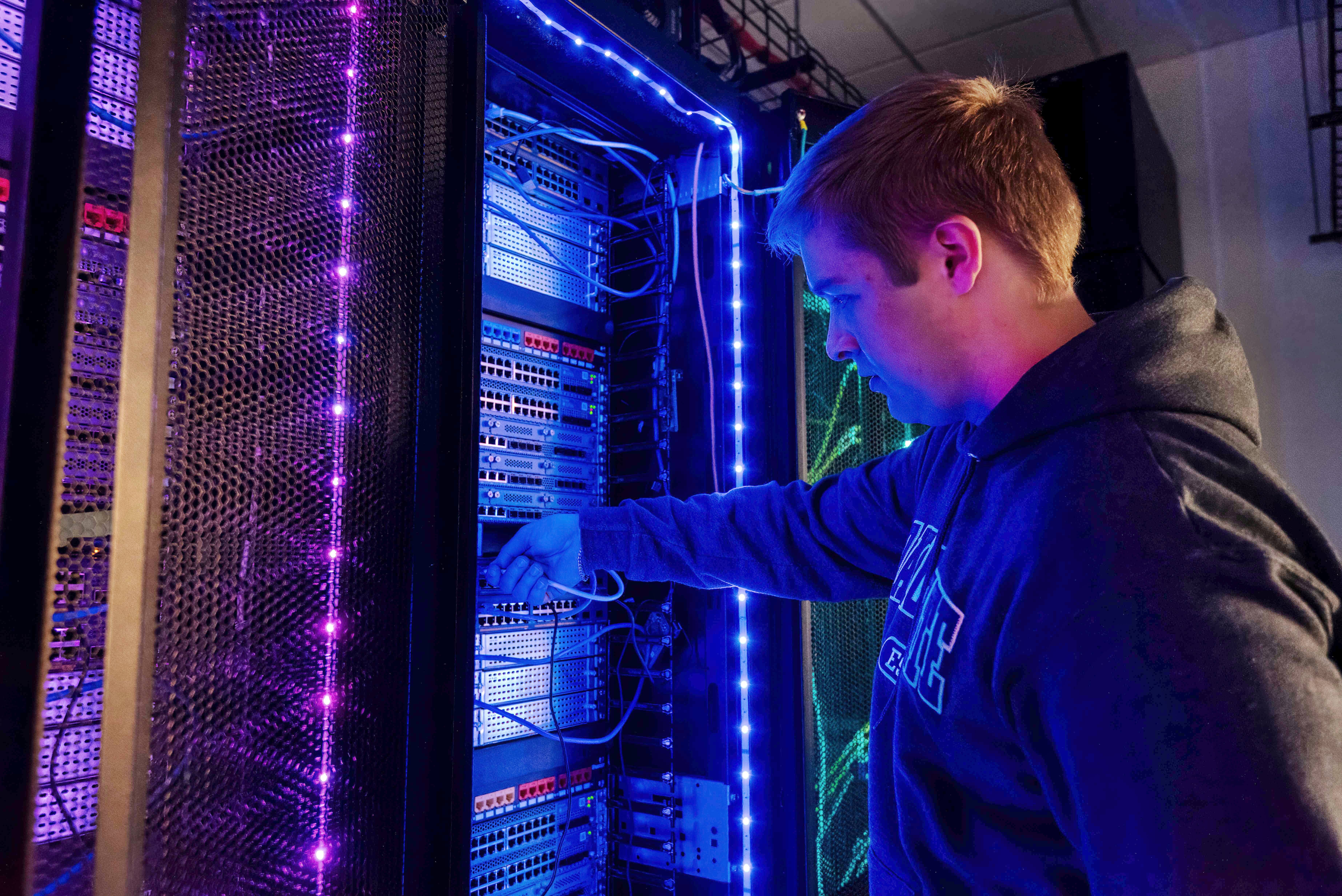 A DSU student works in a computer server room.