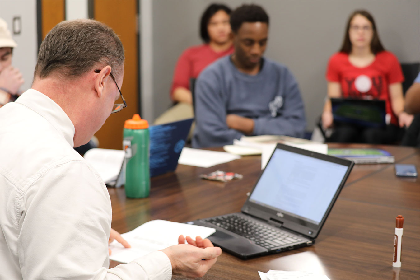 Kurt Kemper, honors program director, rolls dice during an interactive honors class.