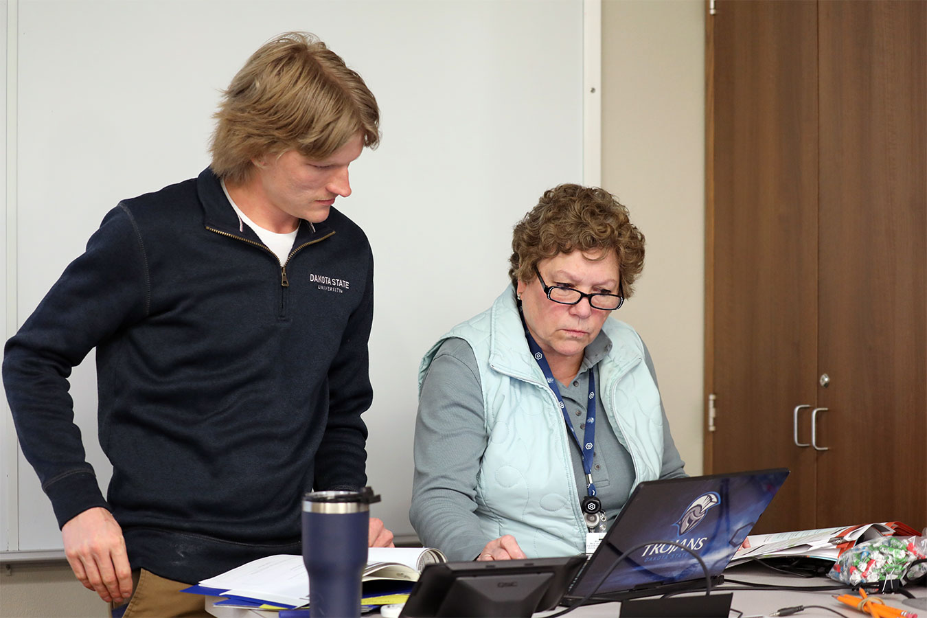 Pictured (l-to-r): Student works with Dr. Patti Brooks in the classroom.