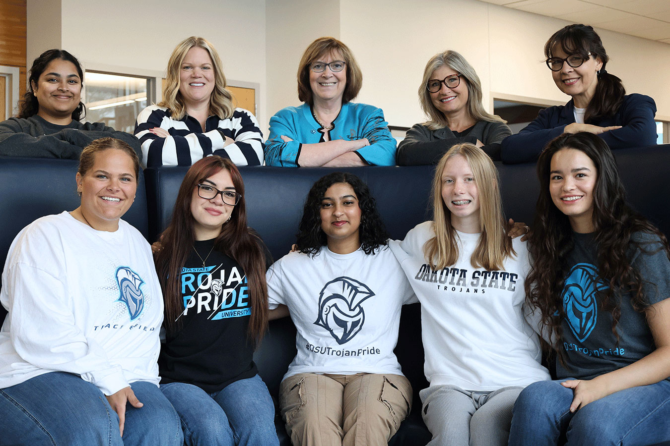 DSU students pose for a photo with (back row l-to-r): Assistant Professor Kanthi Narukonda, Dr. Ashley Podhradsky, President Jose-Marie Griffiths, Provost Rebecca Hoey, and Dean Mary Bell.