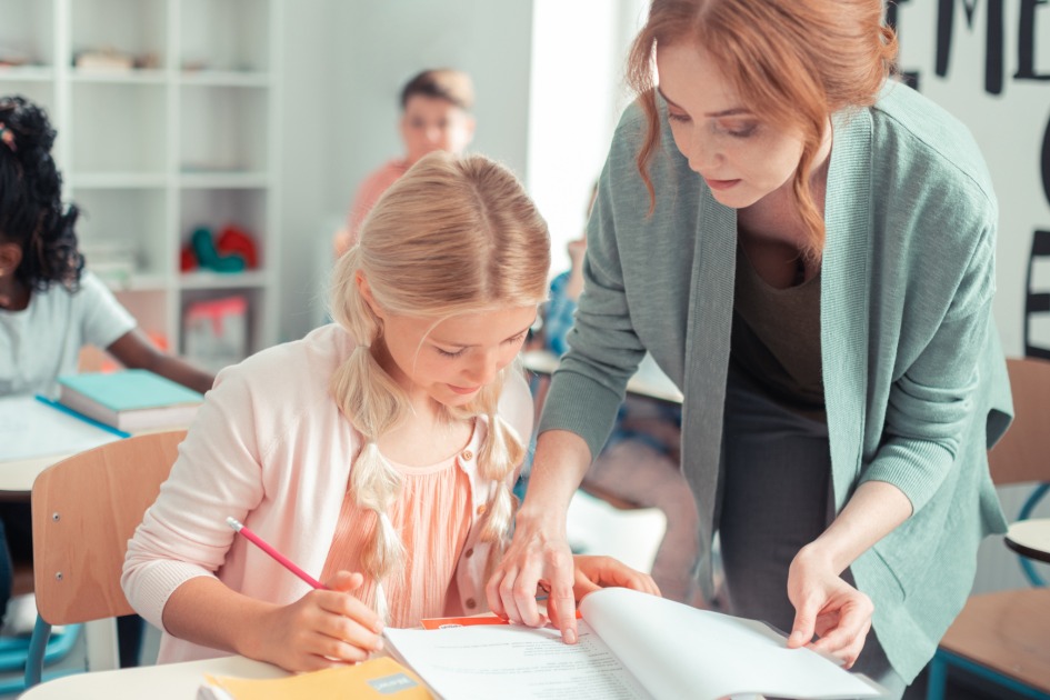 DSU graduate teaching a classroom of students