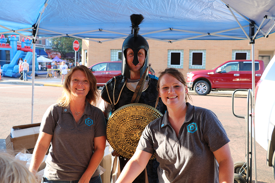 HR team members Kandi Lurz and Alicia Entringer pose for a photo with Trojan Troy during Downtown Madtown