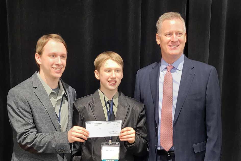 CEO President, Justice Forster, left, with his brother, Pack, receive award from Steve Westra at the Governor’s Giant Vision Competition.
