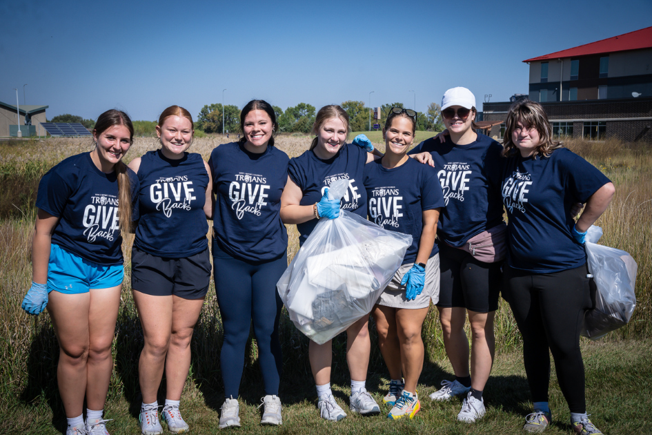 dsu students smiling for photos at trojans give back event