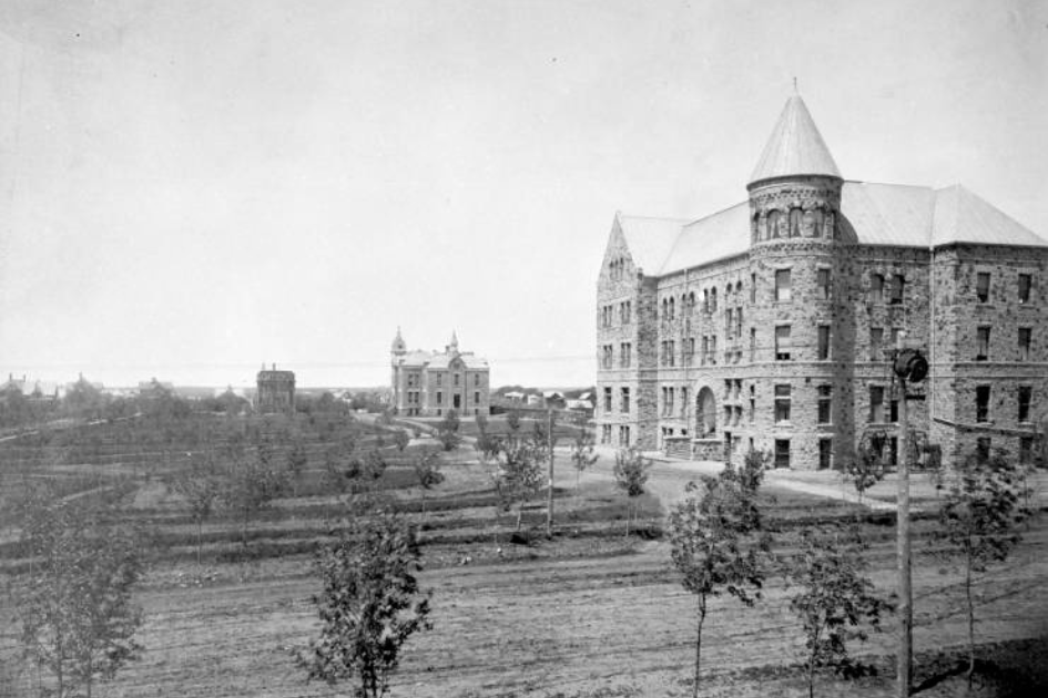 Historical photograph of DSU campus showing East Hall in the foreground. 