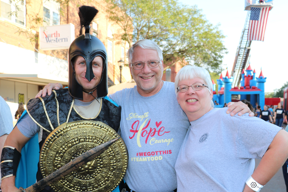 DSU Trojan mascot with community members at Downtown Madtown event.