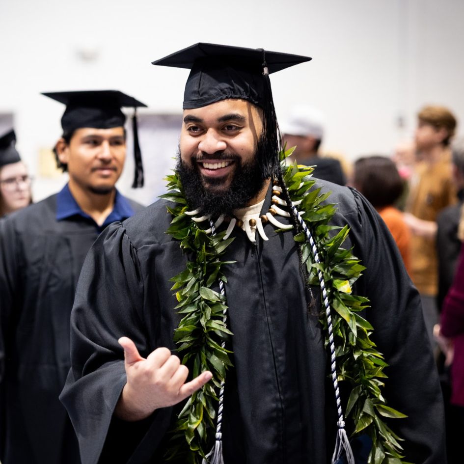 dsu student smiling at commencement with cap and gown