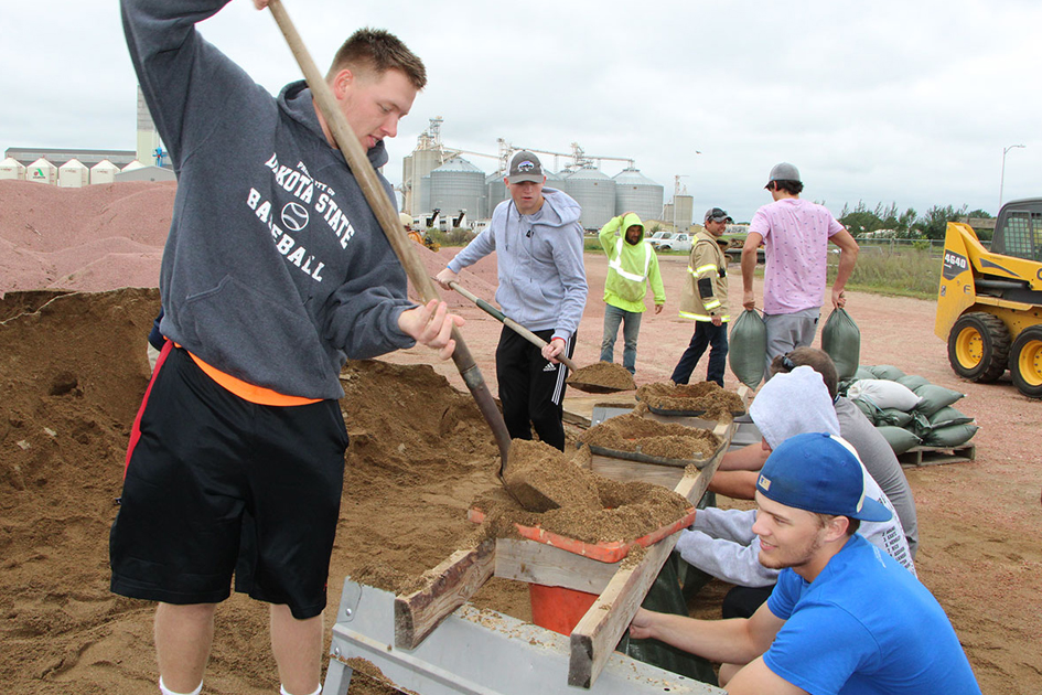 DSU Trojans showed their support by sandbagging and removing debris in affected homes. 