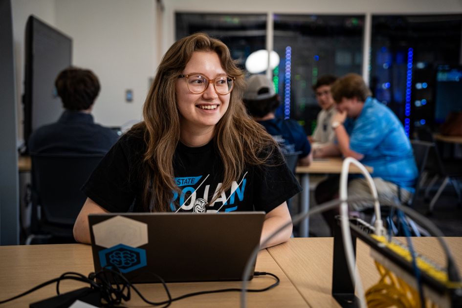 beacom student sitting in classroom smiling