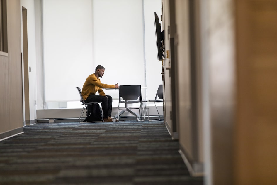 student at desk with computer