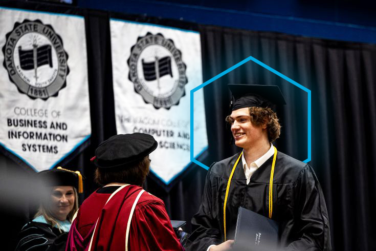 dsu student walking across stage at commencement