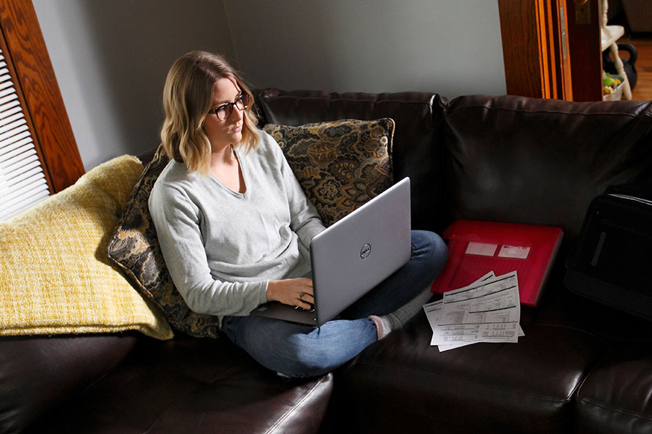 Online student studying on couch at home