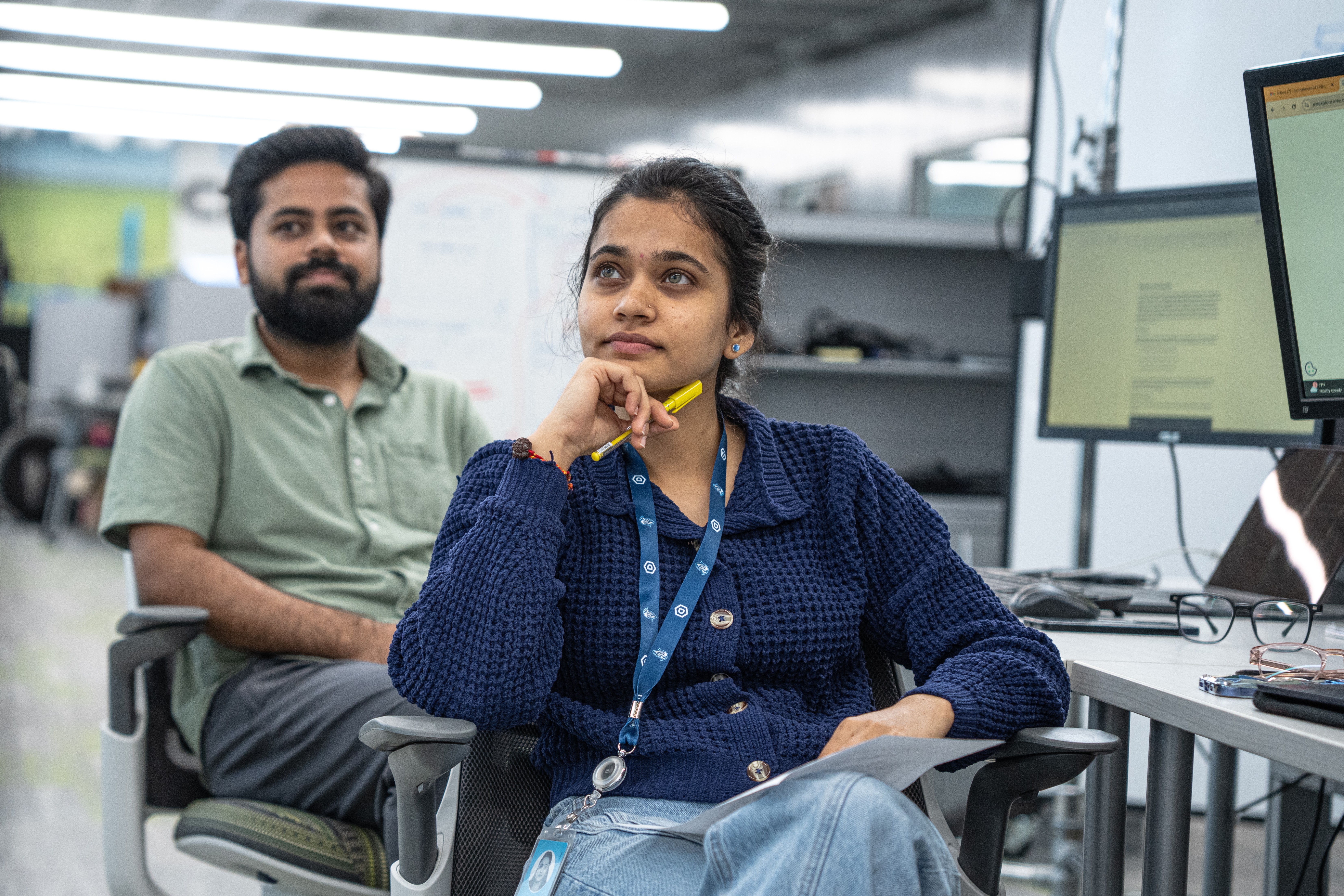 two dsu student in mad labs listening to professor