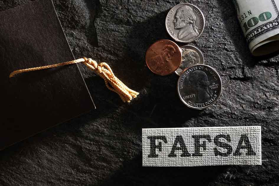 FAFSA lettering amongst a background including change, dollar bills, and graduation hat