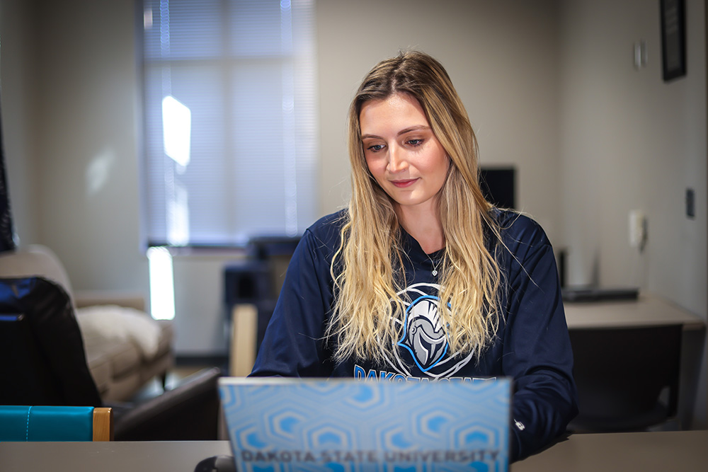 Dakota State Unviersity graduate student studying remotely on her university laptop.