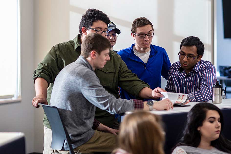 group of students around table