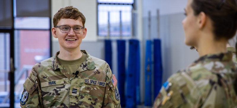 dsu rotc cadet smiling at other cadet in uniform