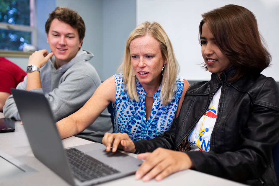 Pam Rowland instructs a student on campus