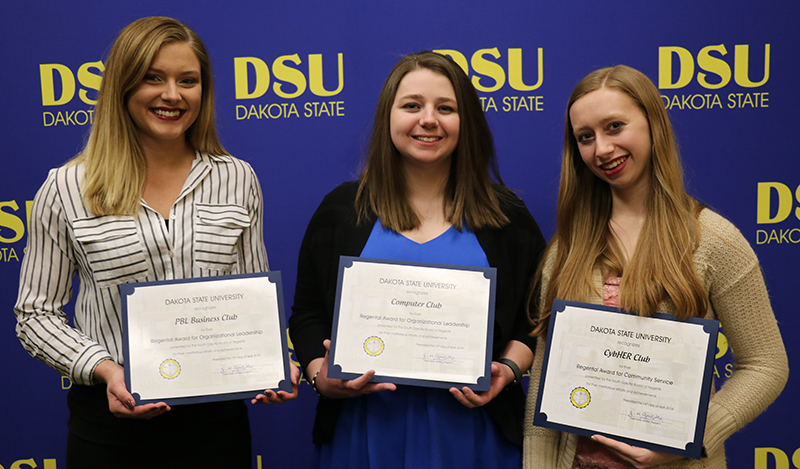 Pictured are Lindsey Vogl (left), representing the PBL Business Club, Ivy Oeltjenbruns representing the Computer Club, and Alexis Vander Wilt representing the CybHER Club.