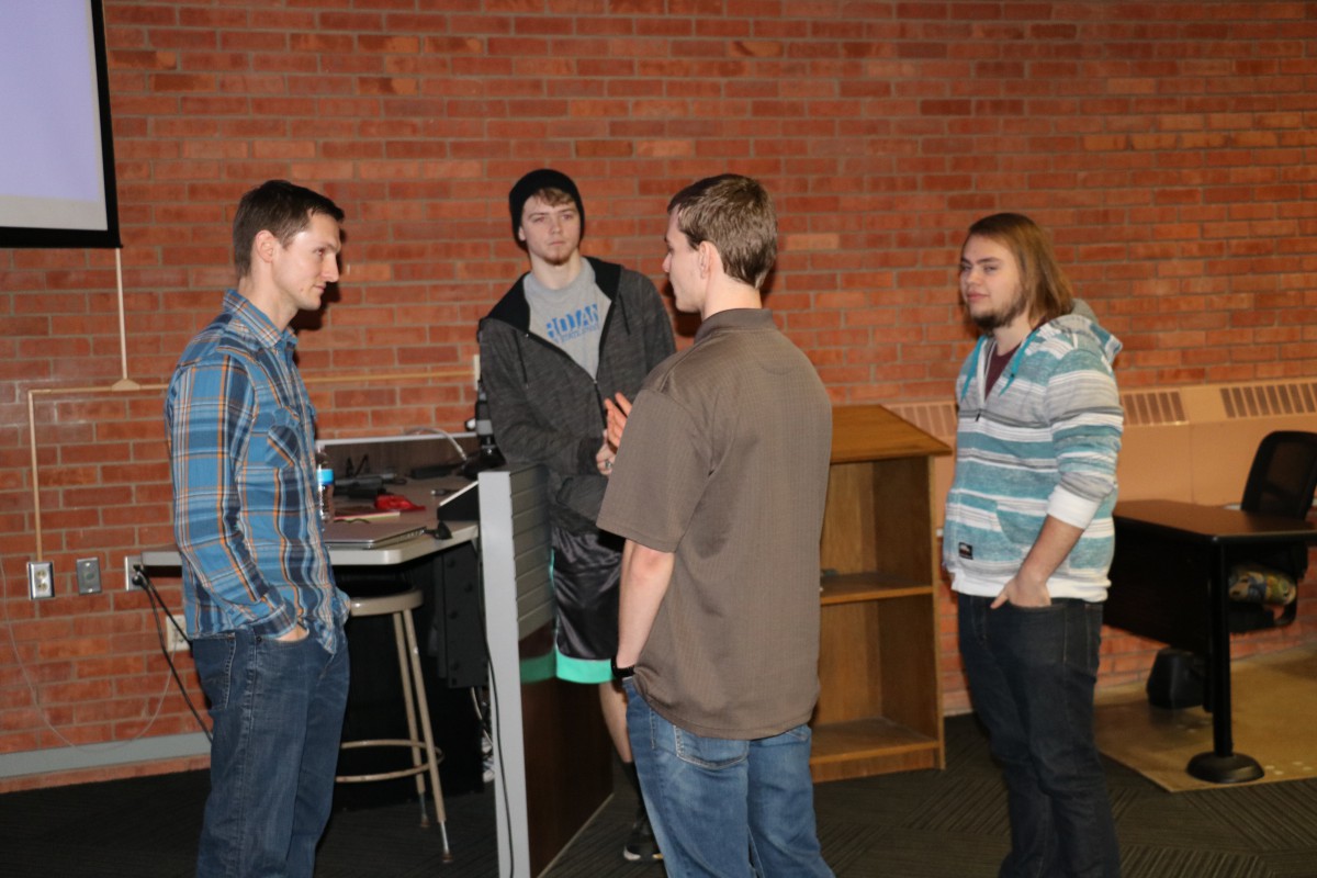 Learn.Create.Build. Academy co-founder Shane Thomas (left) visits with DSU students Zach DeGroot, Christian Ries, and Tyler Rau after a presentation on how to start a technology business. Thomas and co-founder Adam Learing (not pictured) are DSU alumni. DeGroot is also an employee of the academy.