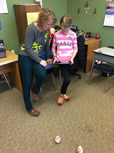 Rowland showing student how BB-8 Sphero operates. 