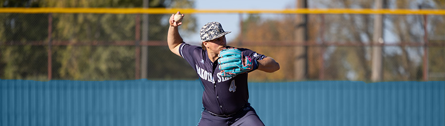 A DSU baseball player exerts himself as he throws a ball.