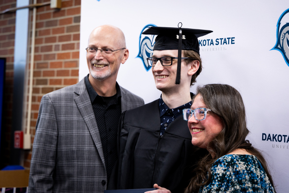 family posing with their graduate
