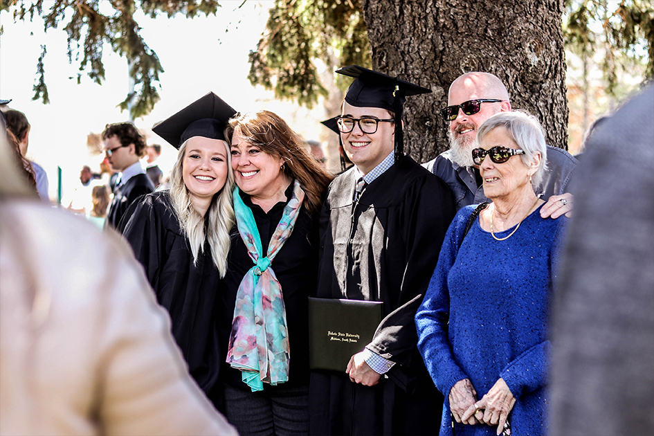 Graduate with family taking photos