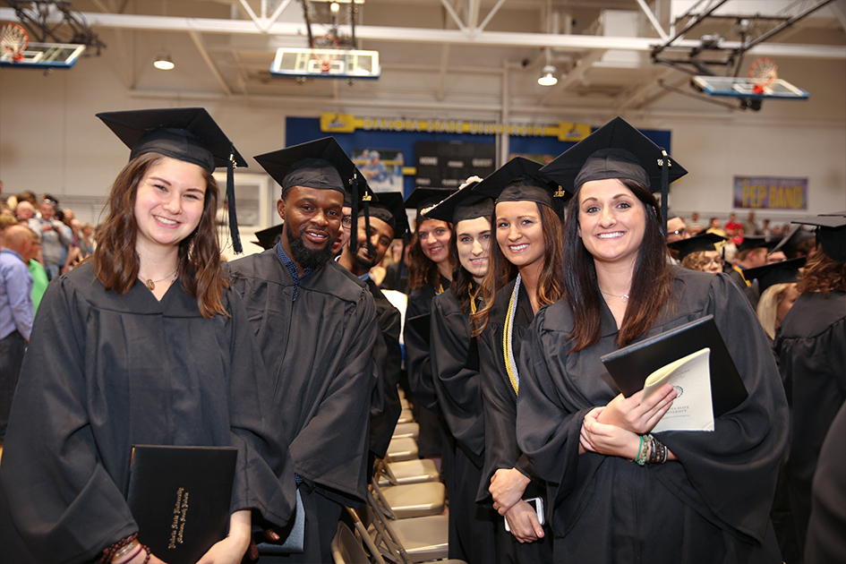 Students holding diplomas