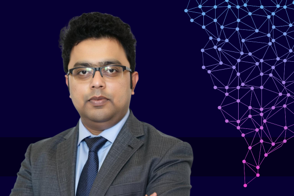 Dr. Varghese Mathew Vaidyan pictured on the left over a dark blue tech background.