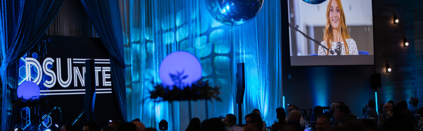 DSUnite event setting with DSUnite written on left side and video showing Paige Phinney on right