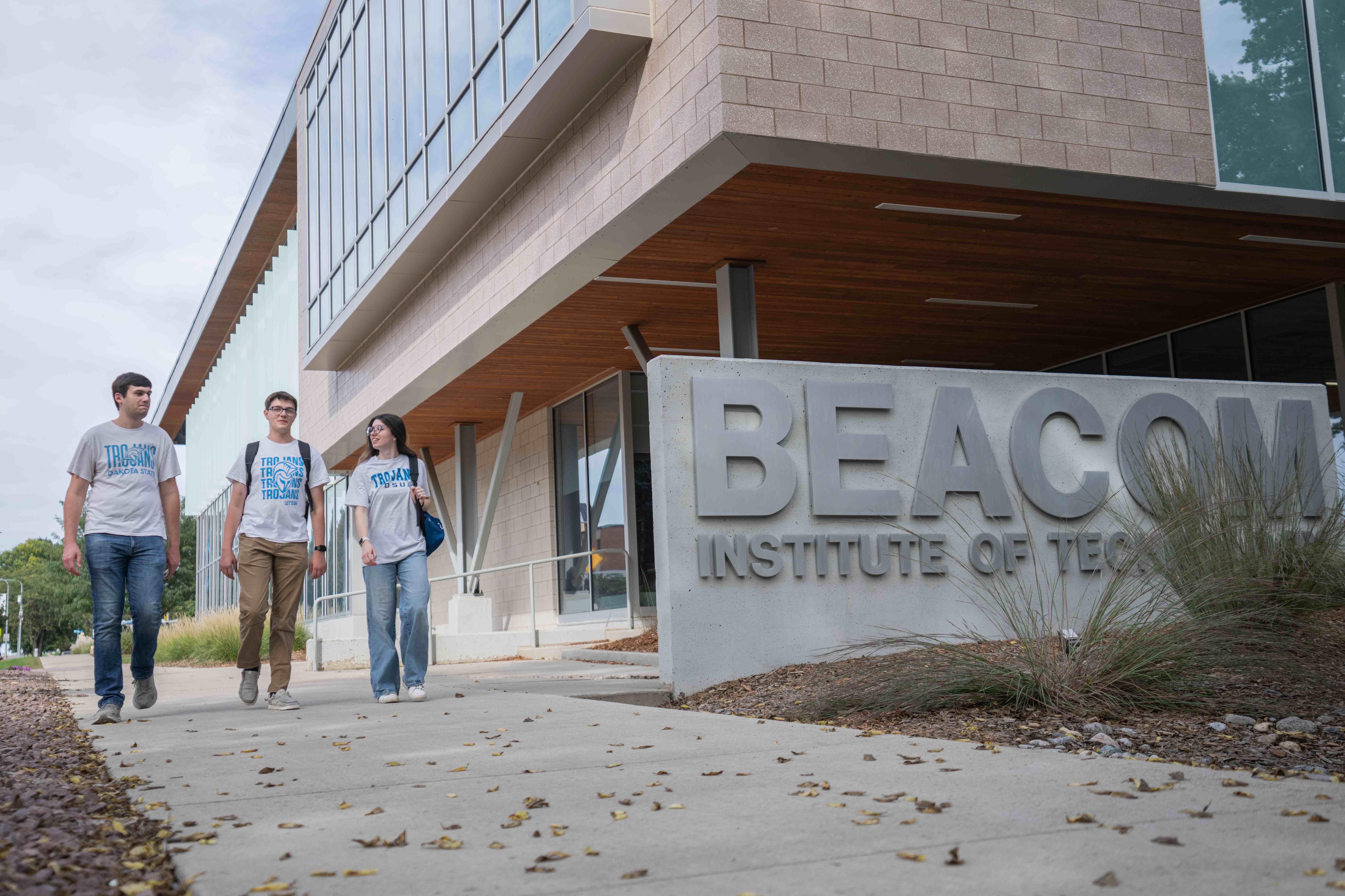 Three DSU students walk past the Beacom Institute of Technology
