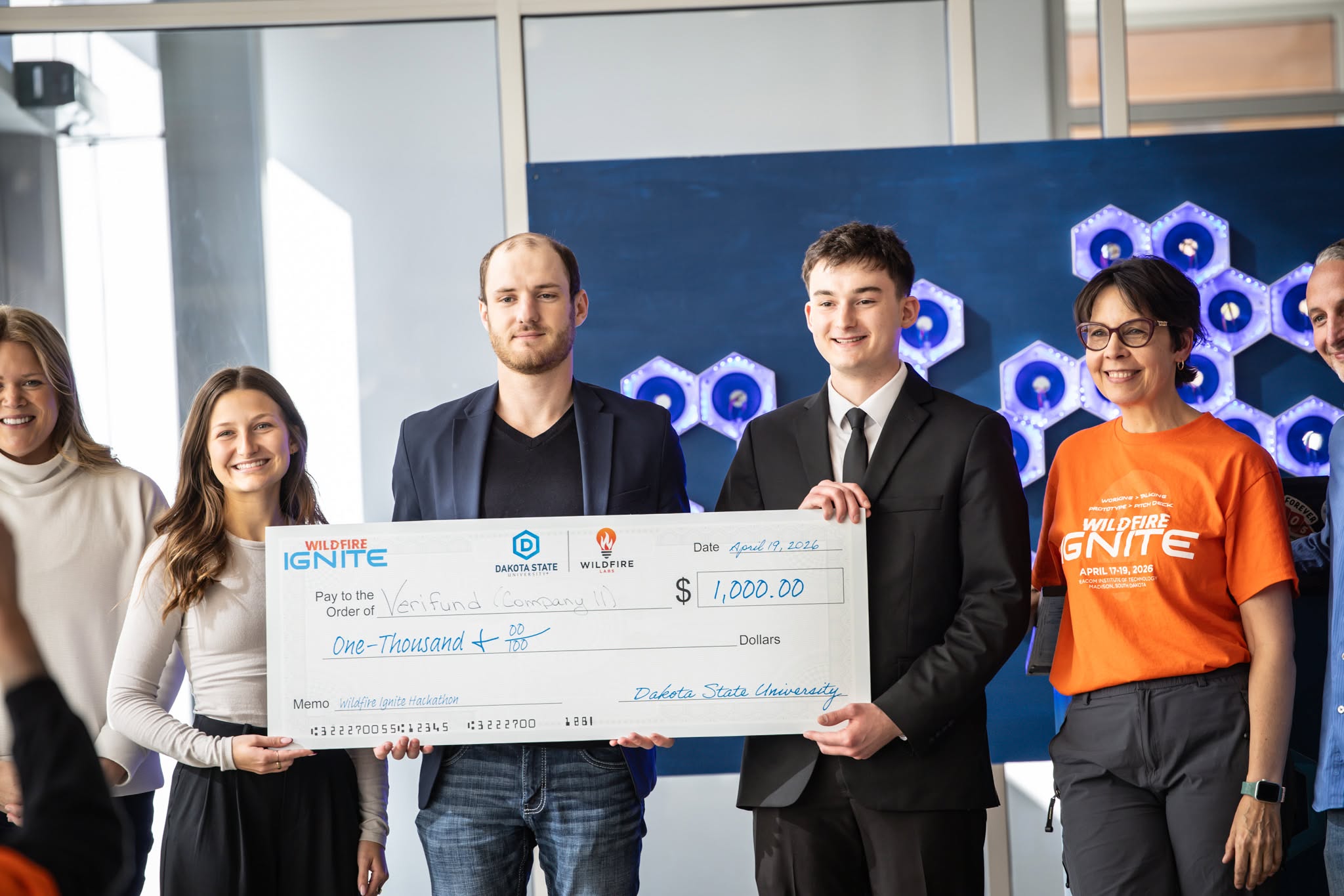 Student winners are presented a winner's check at the hackathon.