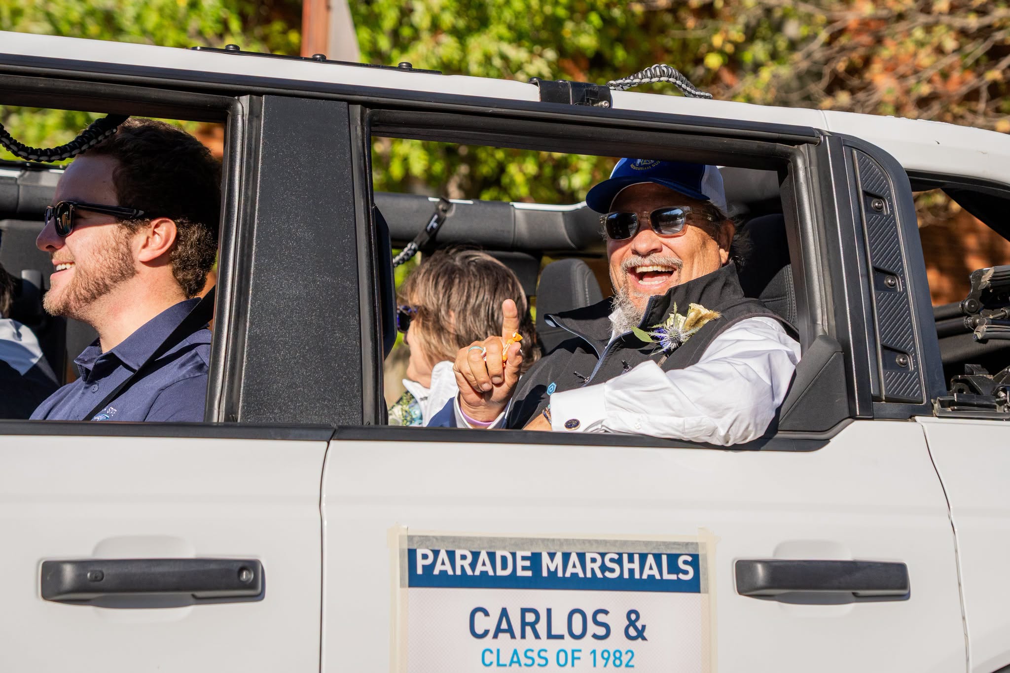 Homecoming Parade Marshal Carlos Cornay waves to paradegoers. 