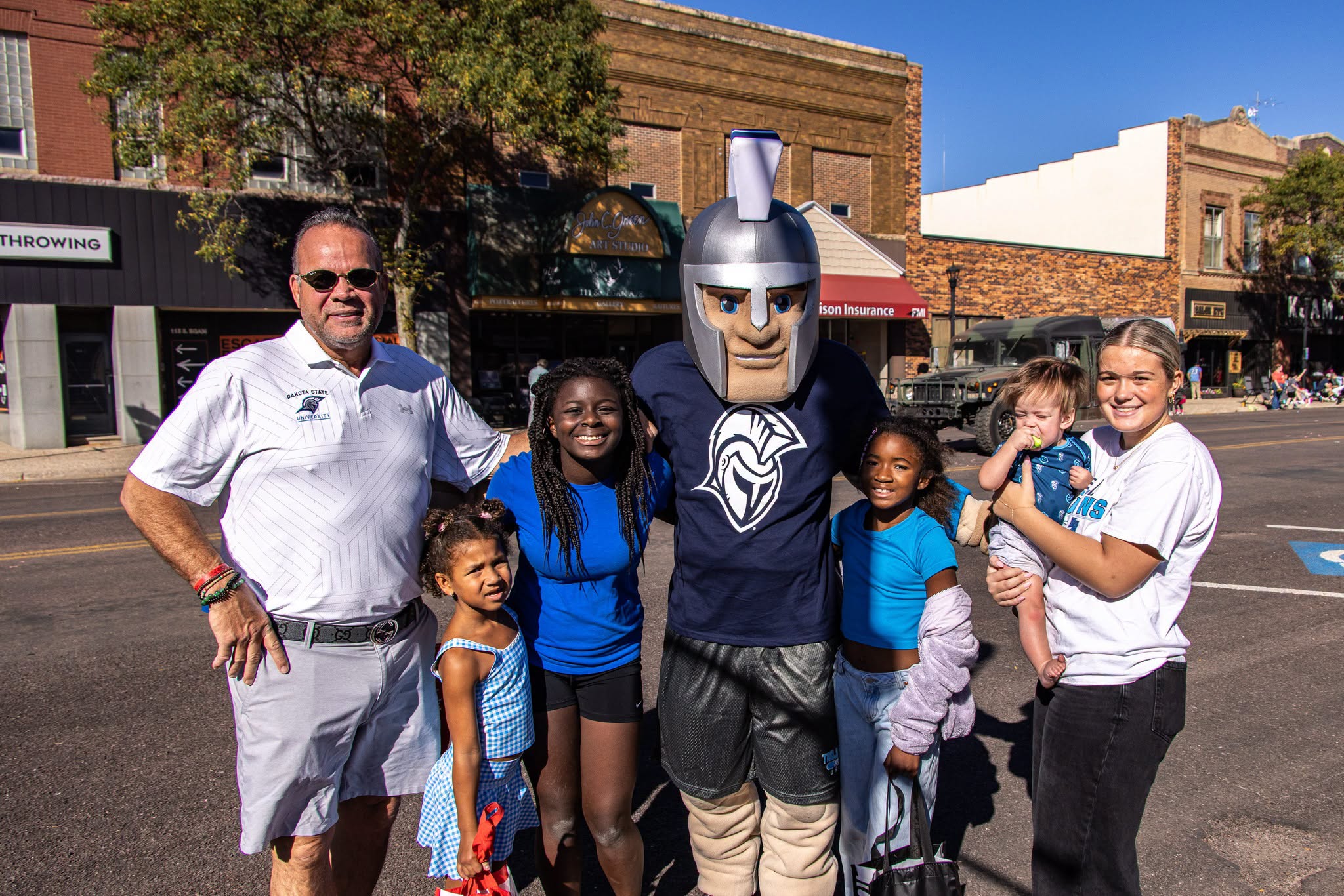 Alumni stand with General Cy at Homecoming Parade