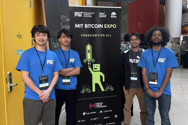 Shun Kasakura, Dijesh Shrestha, Shishir Poudel, and Sarad Gaihre in front of MIT Bitcoin Hackathon Banner