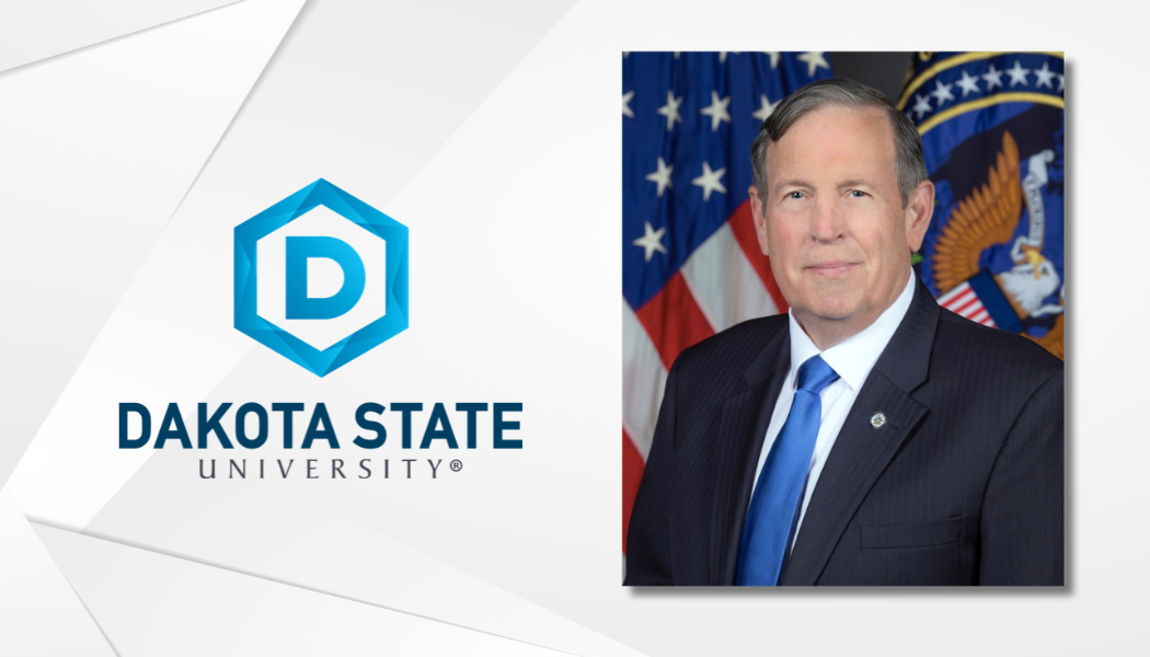white textured background with dakota state university logo on left and photo of Dr. John Ballard on right