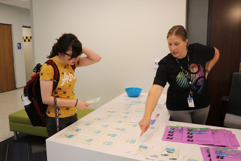 Nicole Bowen shows a student temporary tattoos at a suicide awareness day in 2019.
