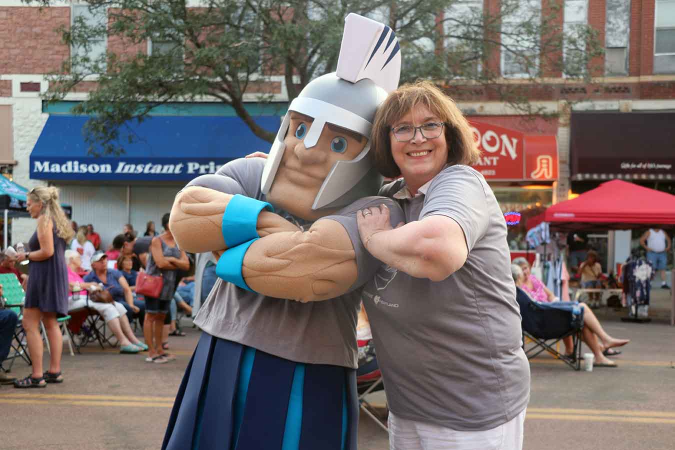 President Griffiths (right) introduces General Cyber to the Madison community at the August 17 Downtown in MadTown event.   