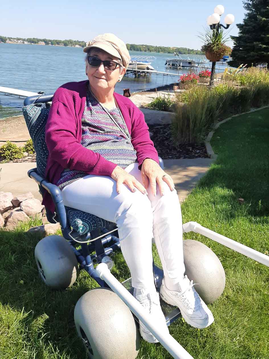 Marietta Faszer sporting the beach wheelchair built by Justin Blessinger with local materials donated by Hyland Machine.
