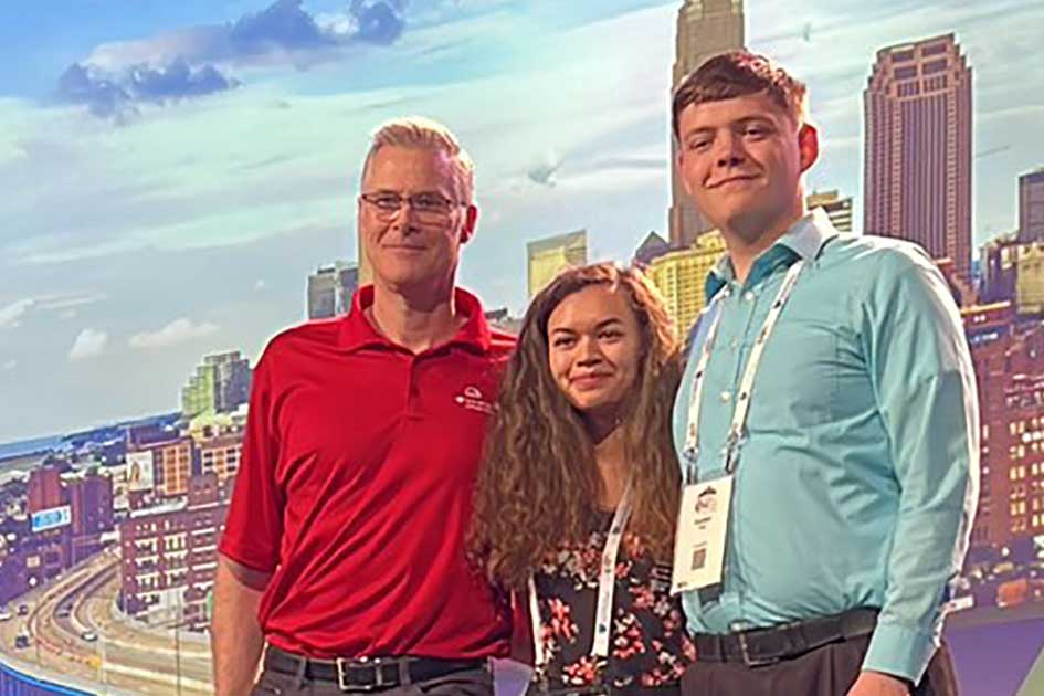 Annabelle Klosterman (center) and Austen King (right), along with teammate Dana Donahue (not pictured), took first in a CTF competition at the spring WiCyS conference. Congratulating the team is the organizer of the Carnegie Mellon CTF (left). 