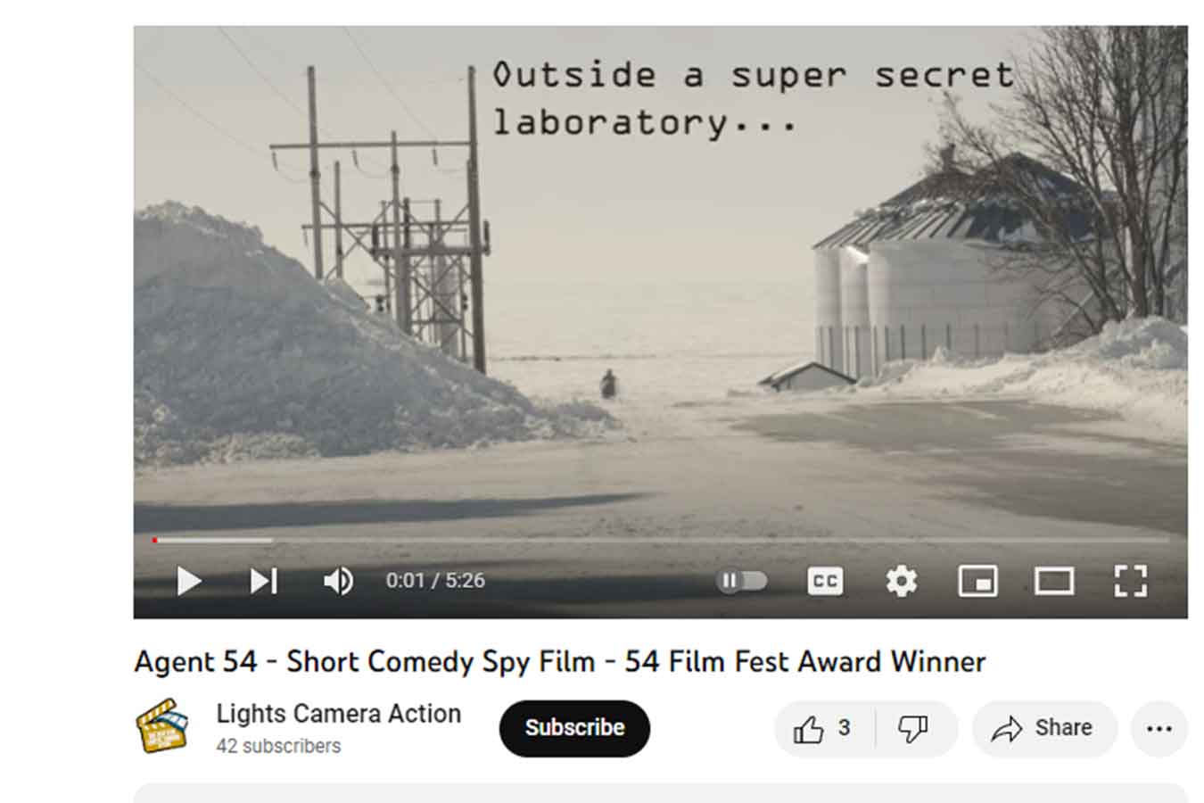 Screenshot of Agent 54, the film, from the LCA Club. It features a figure in the distance running toward the camera in snowy terrain. 