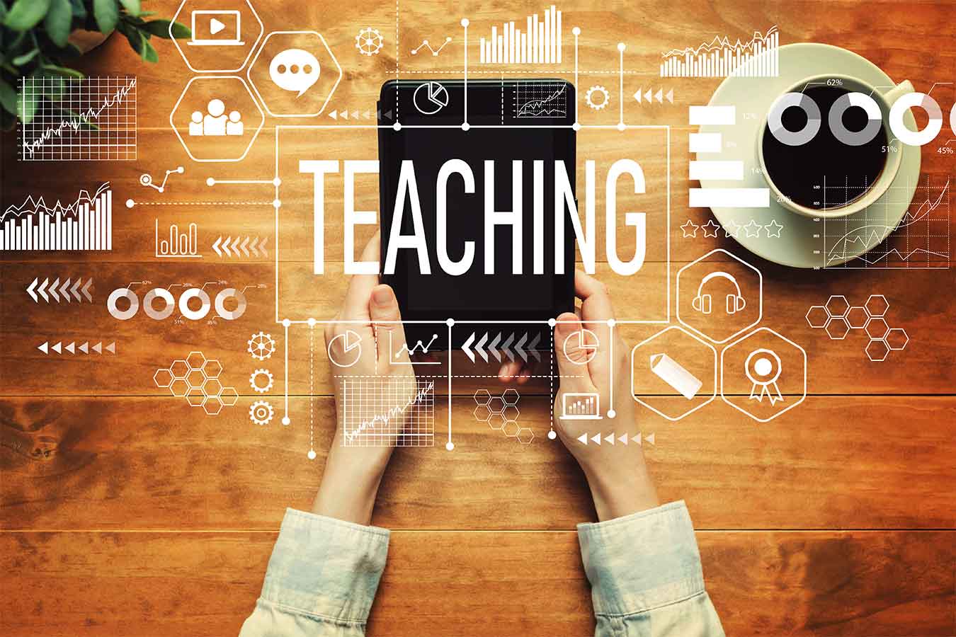 Stock image of hands holding a tablet with graphs and symbols over it surrounding the word teaching in a box.
