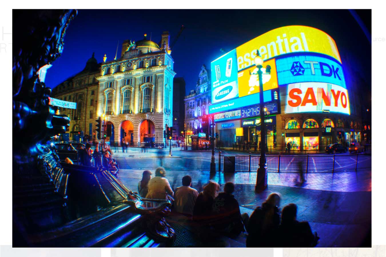 Night photo of Piccadilly in the United Kingdom featuring the neon signs, historic architecture, and fountain that draw tourists and locals alike. This image was taken at night with long exposure, creating blur motion in the image.