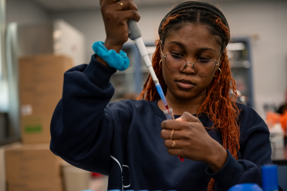 dsu biology student in lab with pipette