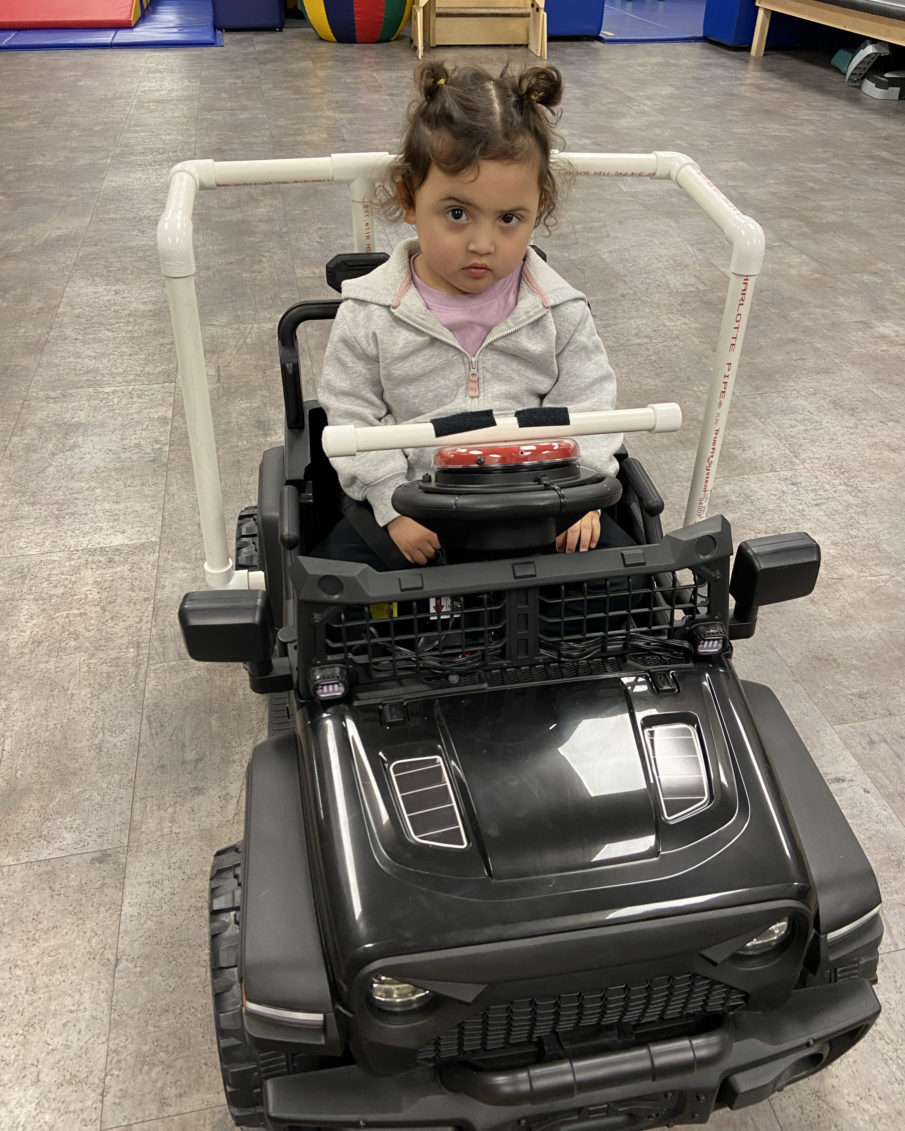 Child, Nova, in her Go Baby Go! vehicle built by DSU