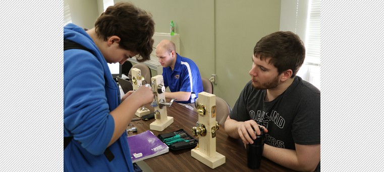 Bergen Weiland (left), a sophomore from Dell Rapids, tries her hand at picking a lock. 